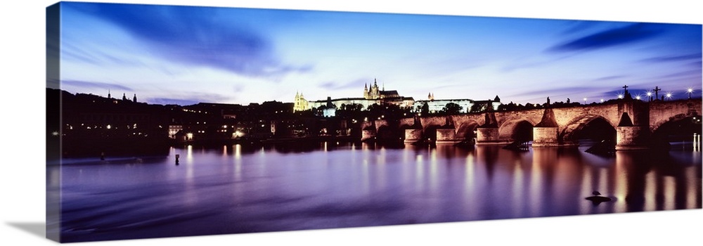 Arch bridge across a river with a cathedral in the background, St. Vitus Cathedral, Hradcany Castle, Vltava river, Prague,...