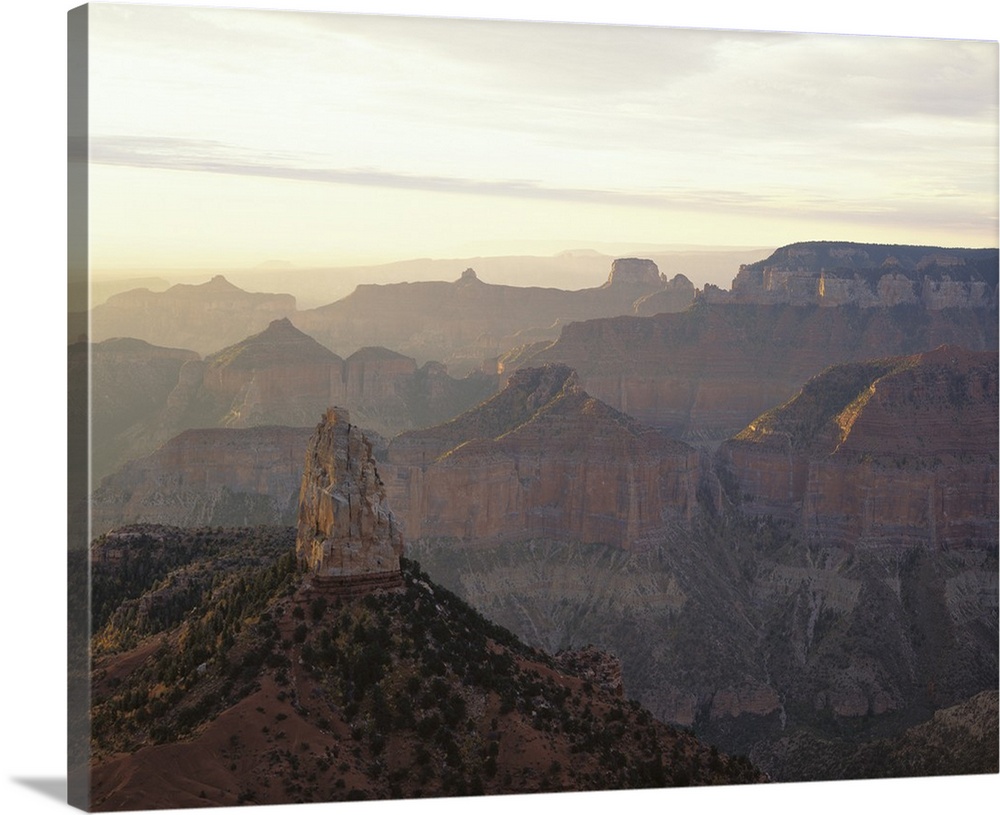 Landscape photograph on a large canvas looking over the vast mountain range in Grand Canyon National Park, as the sun sets...