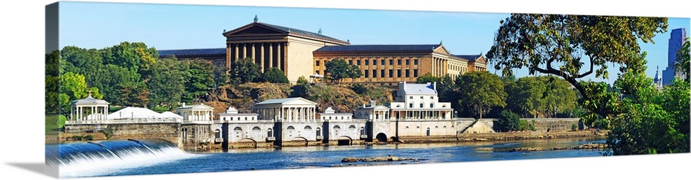 Wall docor of an art museum in Philadelphia by the water with a waterfall flowing on the left.