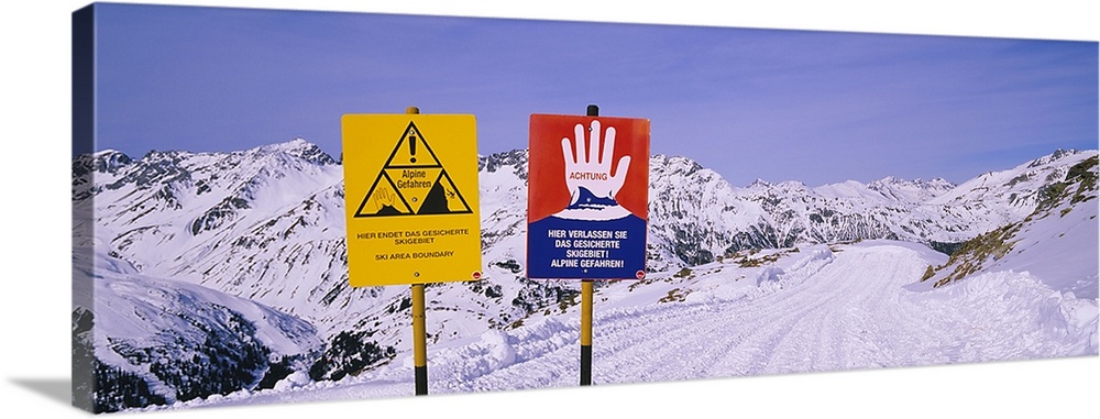 Avalanche warning signs on snowcapped mountains, Rendl Ski Area, St. Anton, Austria
