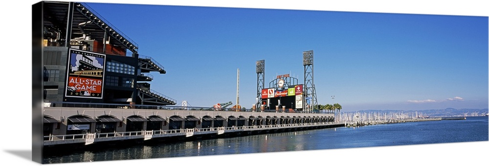View from the bay of a baseball stadium under a clear blue sky, with the city skyline in the distance.