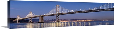 Bay Bridge suspension bridge over Pacific ocean lit up at dusk, San Francisco