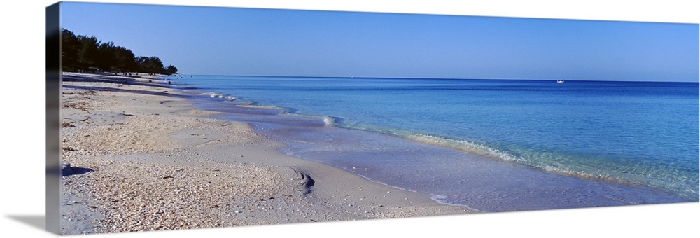 Horizontal canvas photo of calm waves rolling ashore from the Gulf of Mexico.