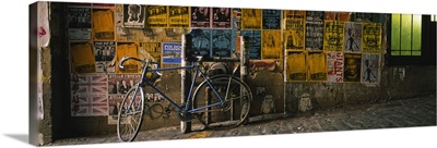 Bicycle leaning against a wall with posters in an alley, Post Alley, Seattle, Washington State