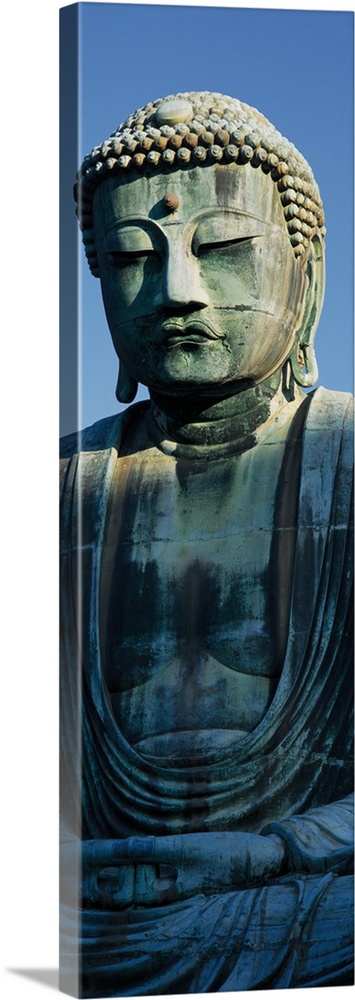 Only part of a Buddha statue is photographed for this tall panoramic piece.