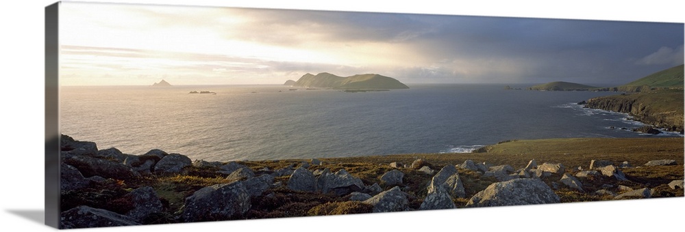 This is a panoramic photograph of the view over a rocky sea cliff and the Atlantic Ocean beyond.