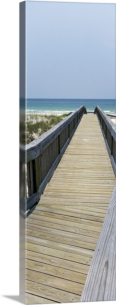 Wooden walkway leading down to the sand and dune grass, the waters of the Gulf of Mexico in the background.