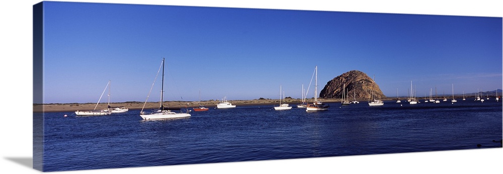 Boats at a harbor with rock in the background Morro Rock Morro Bay California