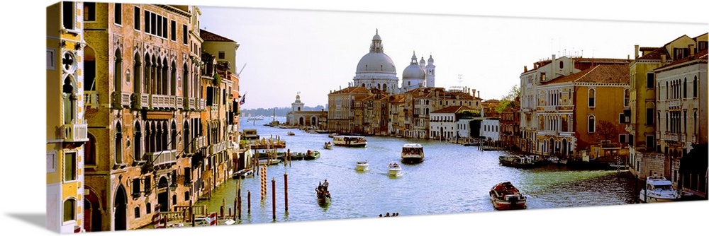 Large panoramic photograph of the busy Grand Canal in Santa Maria della Salute, Venice, Veneto, Italy. Old buildings line ...