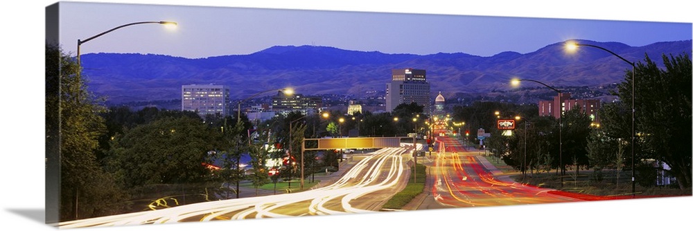 Panoramic photograph taken of a major highway in Boise with the lights of the cars shown as streaks on the road.