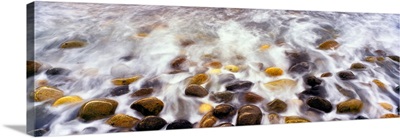 Breaking wave and pebbles at Calumet Beach, California