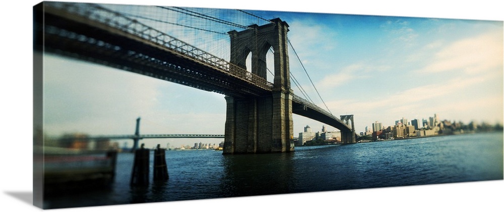 This elongated piece is a photograph taken of the Brooklyn Bridge from the Manhattan side.