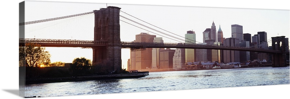Panoramic photograph of iconic overpass in the ""Big Apple.""  Water is below and the city skyline is in the distance unde...