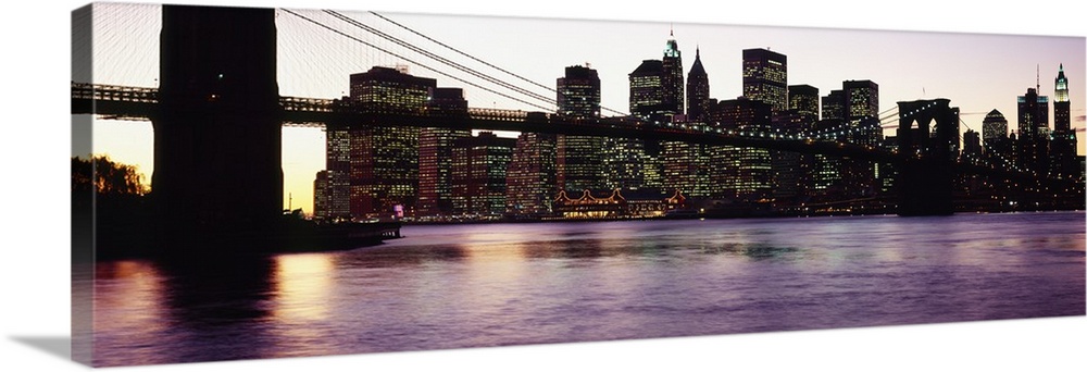 This decorative wall art is a panoramic photograph taken from ground level of the base of the suspension bridge and the ci...
