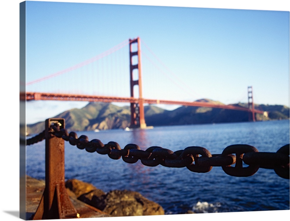 Large, landscape photograph of a chain running on the top of a retaining wall near the San Francisco Bay, the Golden Gate ...