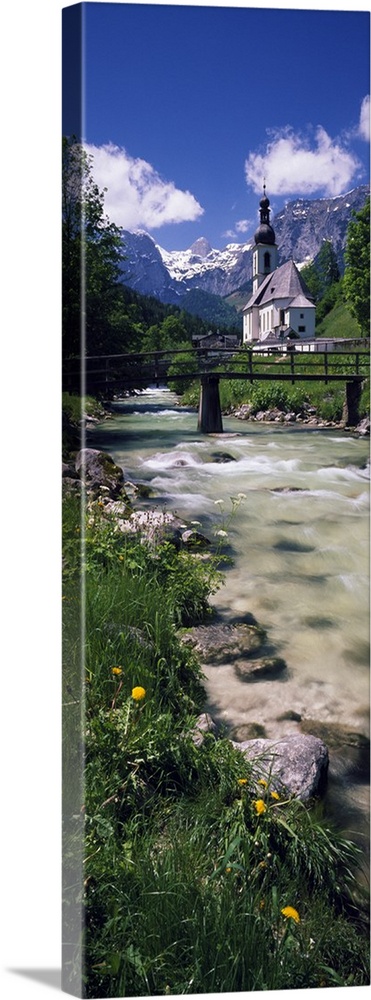 Bridge over stream below country church, Bavarian Alps, Germany