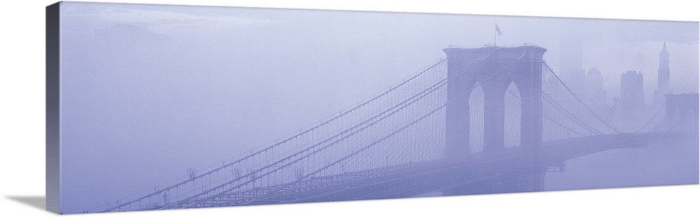 Panoramic photograph on a giant wall hanging of fog surrounding New York's famous Brooklyn Bridge.  Part of the New York C...