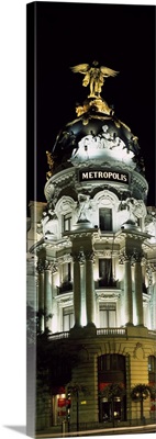 Building lit up at night, Metropolis, Madrid, Spain