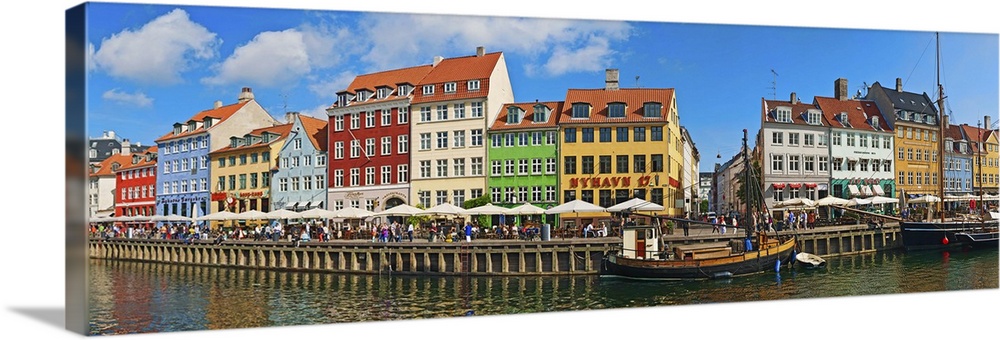Buildings along a canal with boats, Nyhavn, Copenhagen, Denmark