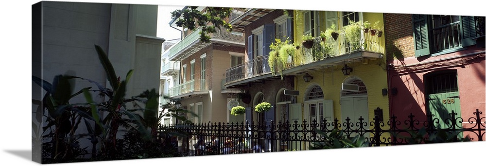Panoramic picture taken of colorful buildings that line a street in New Orleans.