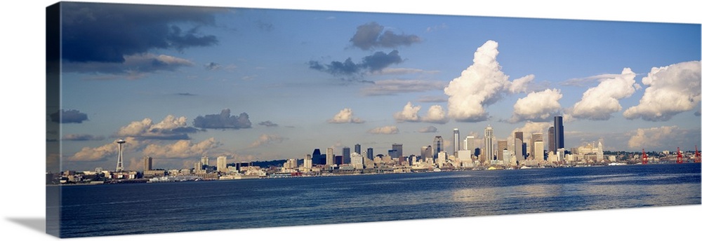 Horizontal photograph on a large wall hanging of the Seattle skyline in the distance, Elliot Bay in the foreground, in Was...