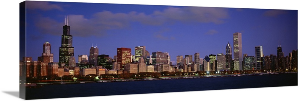 Panoramic photograph displays the busy skyline of a famous city within the Midwestern United States during a sunny day.  I...