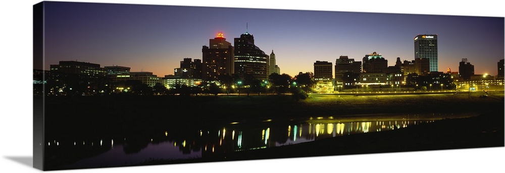 Panoramic skyline of Memphis, Tennessee as the sun begins to rise over the Mississippi river.