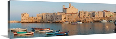 Buildings at the waterfront with boats at harbor, Giovinazzo, Puglia, Italy