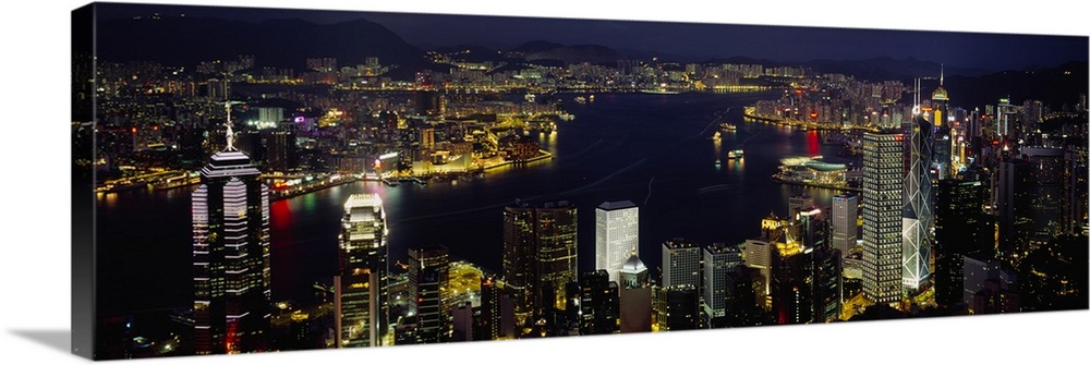 Panoramic photograph shows a nighttime aerial view overlooking a busy city-state that is enclosed by the Pearl River Delta...