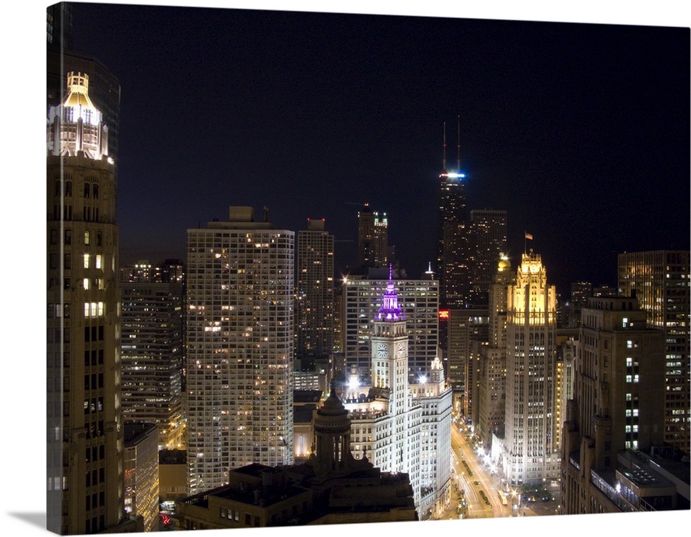 Large photograph of downtown Chicago, Illinois (IL) lit up at night featuring the Magnificent Mile, Upper Michigan Avenue,...