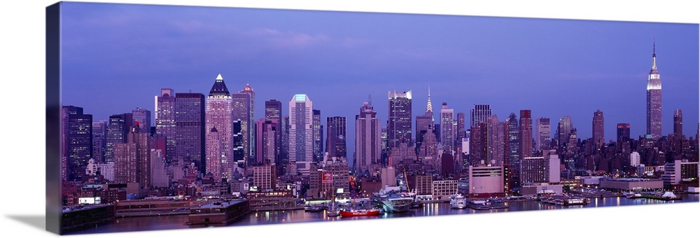 This panoramic photograph was taken at dusk of the Manhattan skyline from across the water.