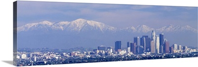 Buildings in a city with snowcapped mountains in the background, San Gabriel Mountains, City of Los Angeles, California