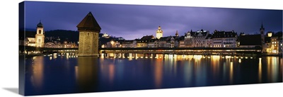 Buildings lit up at dusk, Chapel Bridge, Reuss River, Lucerne, Switzerland