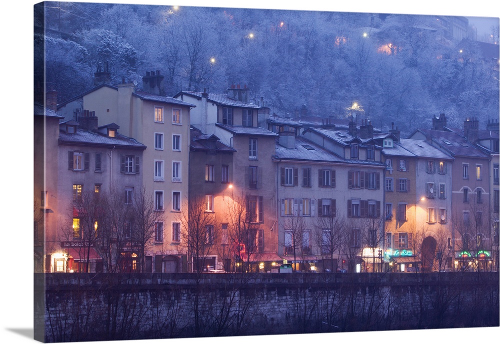 Buildings lit up at dusk, Isere River, Grenoble, French Alps, France