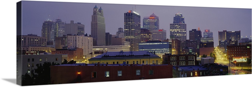 A panoramic photograph of the downtown city skyline with several small residential or warehouse buildings with historic ar...