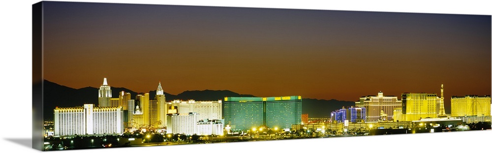 Wide angle, distant photograph of the brightly lit Las Vegas skyline, at night.