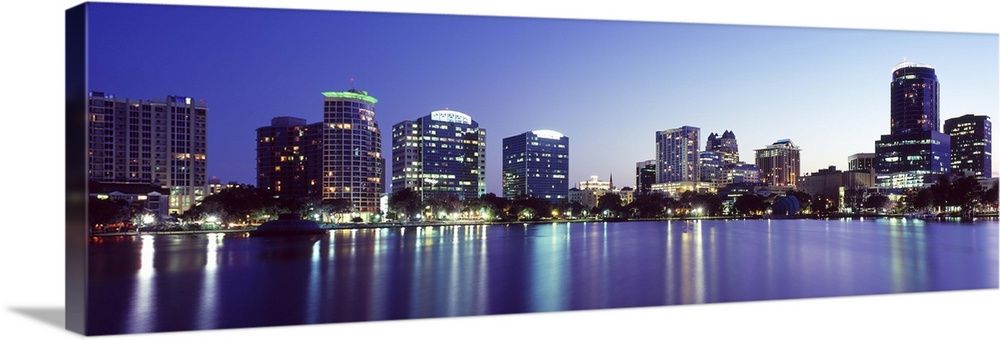 Buildings lit up at night in a city Lake Eola Orlando Orange County Florida