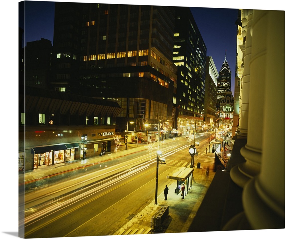 Large photo on canvas of tall buildings and a busy street lit up in Philly.