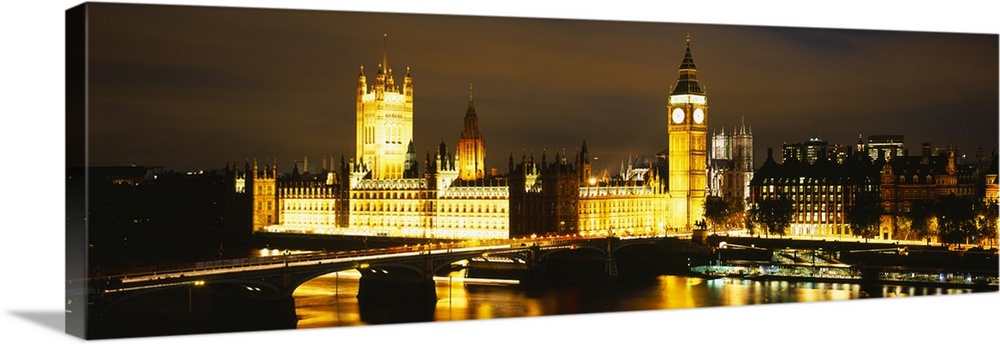 This panoramic piece shows the Big Ben clock tower and the House of Parliament illuminated under a dark night sky.