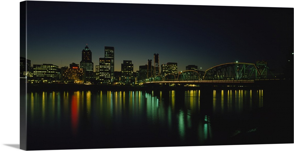 Panoramic photograph taken of a busy city in the Northwestern United States during nighttime.  The colorful lights of the ...