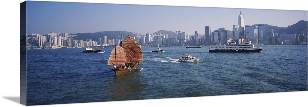 Panoramic print of ships sailing in the ocean with a downtown cityscape in the distance meeting the water.