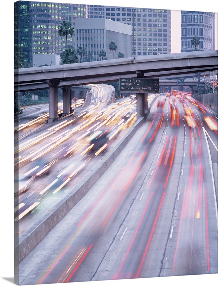 Streaks of lights are photographed as traffic in Los Angeles moves quickly in either direction down the freeway.