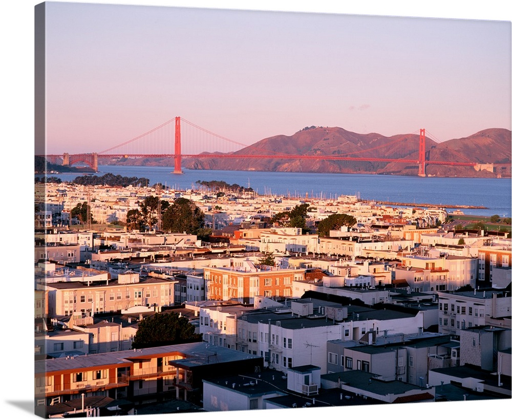 This decorative wall art is a photograph of houses around the bay and the Golden Gate Bridge in the distant background.