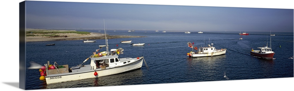 Long and horizontal photo print of boats coming out of a harbor in Massachusetts.