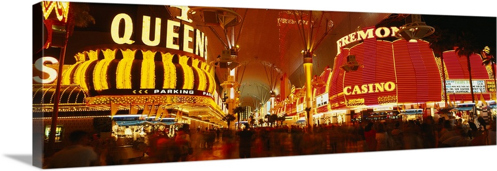 Wide angle photograph on a giant canvas of the casinos with bright lights at night, along Fremont Street in downtown Las V...