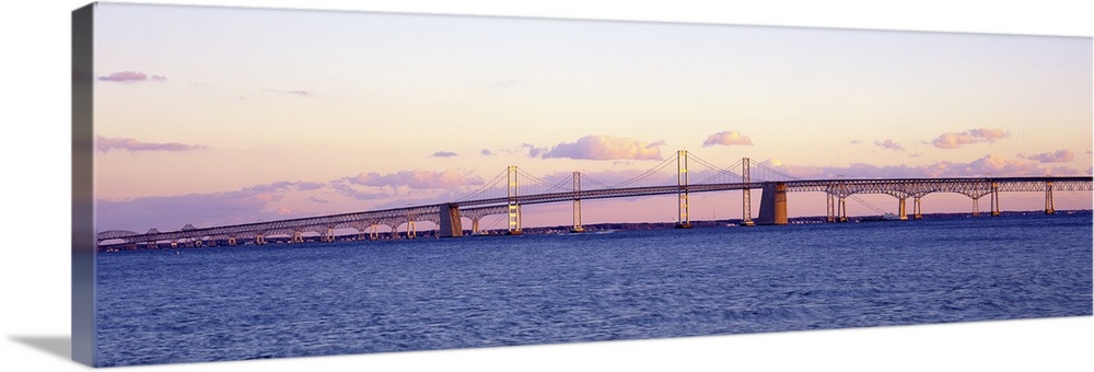 This large panoramic shot is taken of the Chesapeake Bay Bridge during a sunset.