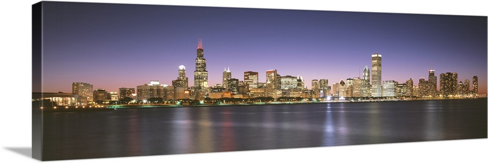 Panoramic photograph composed of the busy skyline of this landmark city in Illinois.  The blurred reflections of the brigh...