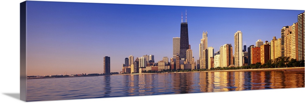 Large panoramic view taken from the water of the Chicago skyline with the sears tower highlighted in the middle.