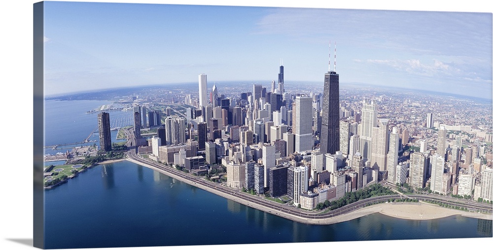 Large, landscape aerial photograph of the large city of Chicago, Illinois, surrounded by calm blue waters.