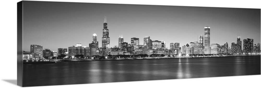 Panoramic monochromatic photograph showcases the busy skyline of a famous city within the Midwestern United States.  The b...